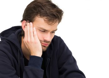 a man suffering from tooth and ear pain