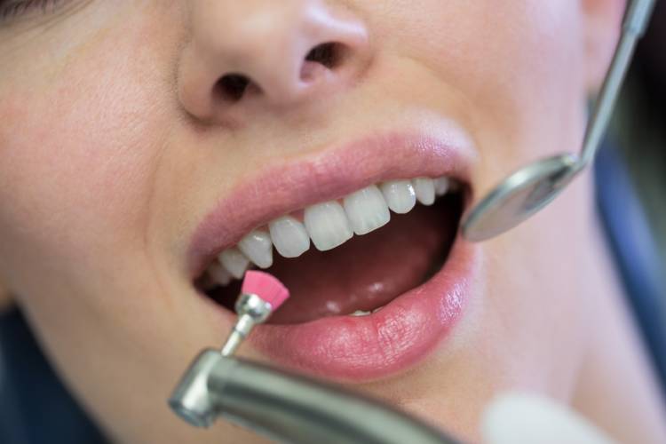 Dentist checks patient's gums and teeth and advice essential vitamins for gums and teeth

