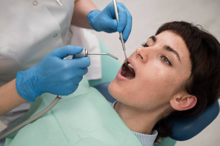 A dentist tries to find infected tooth and recommends root canal alternatives