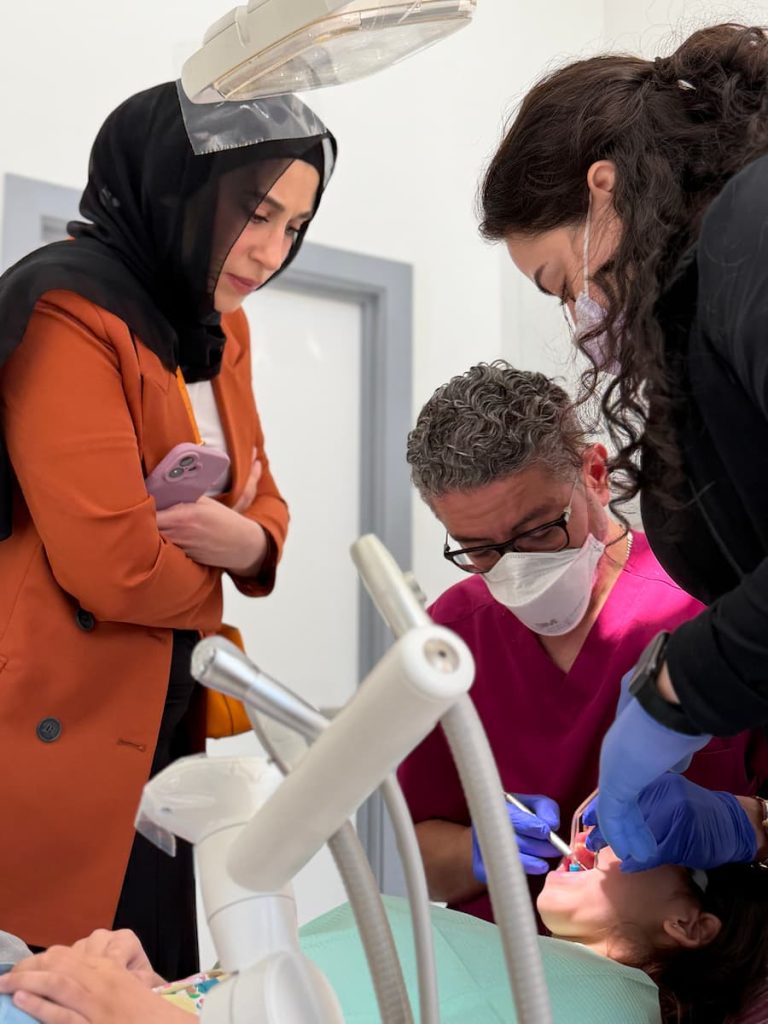 Dental procedure with attentive observers.