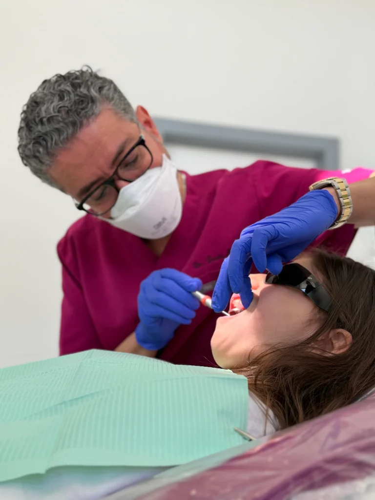 Dr. Abudaqa examining the child's teeth